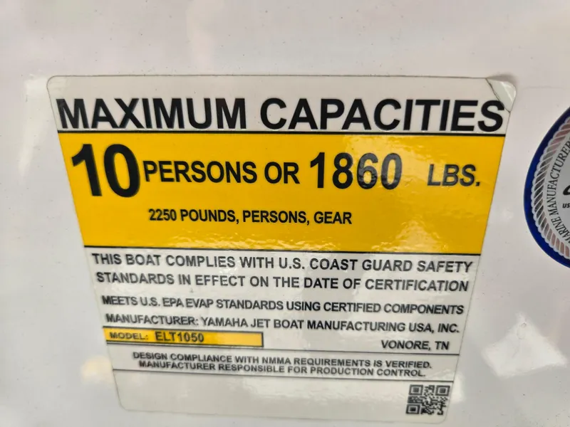 Slide: The Image of Yamaha Boats 2022 210 FSH Deluxe capacity label: 10 persons or 1860 lbs, safety compliance. - 22