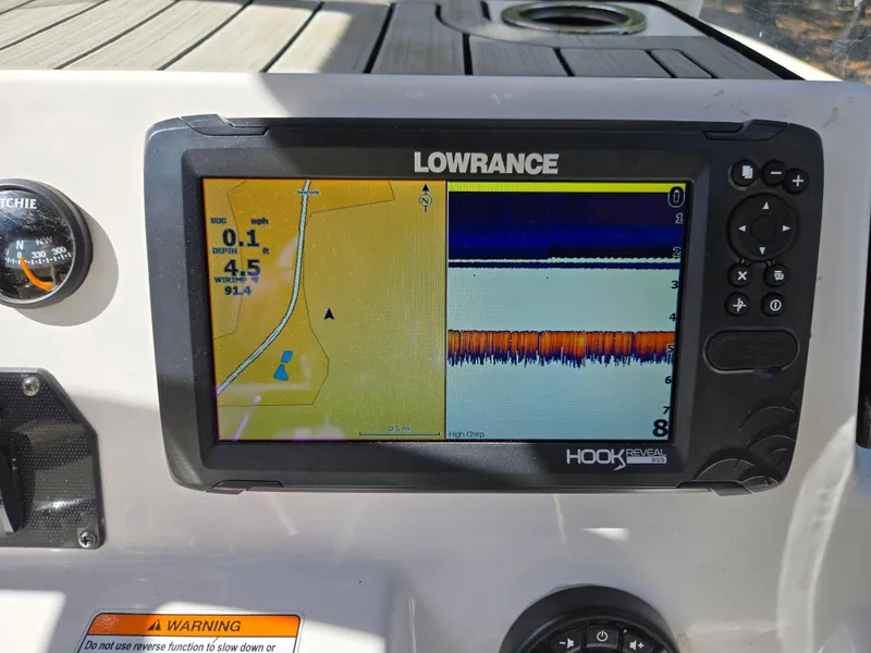 Slide: The Image of Lowrance Hook Reveal GPS on 2022 Yamaha Boats 210 FSH Deluxe dashboard. - 26