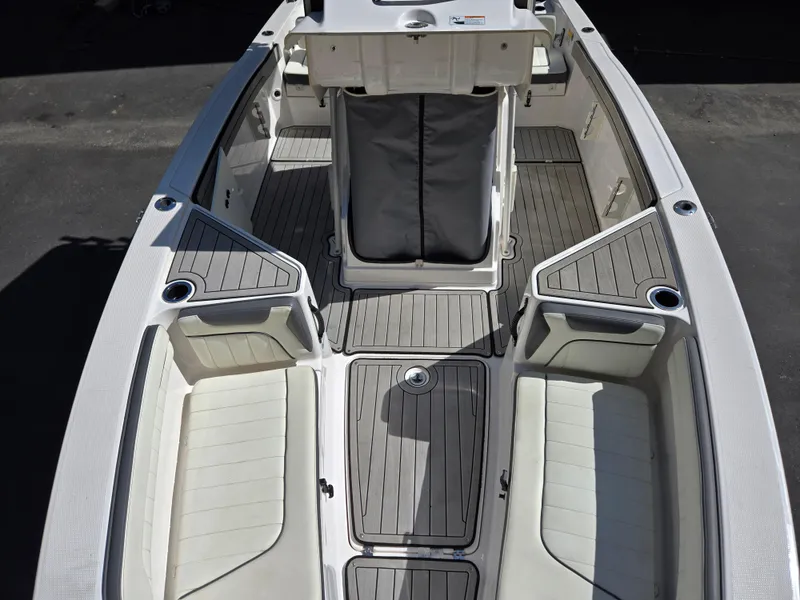 Slide: The Image of 2022 Yamaha Boats 210 FSH Deluxe interior with seating and storage compartments. - 7