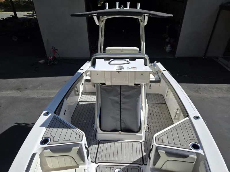 Slide: The Image of 2022 Yamaha Boats 210 FSH Deluxe interior with seating and storage compartments. - 8