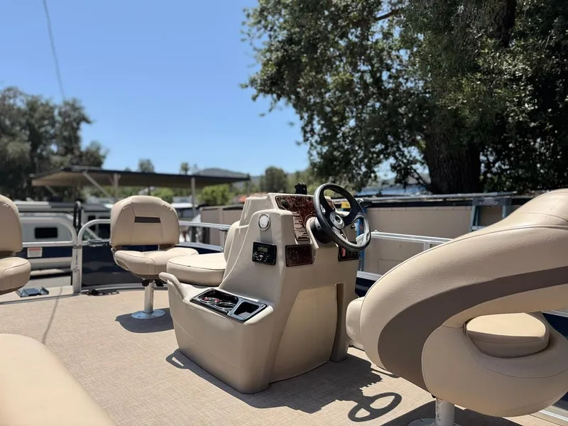 Slide: The Image of 2023 Sun Tracker Bass Buggy 16 XL Select interior with steering console and seating. - 12