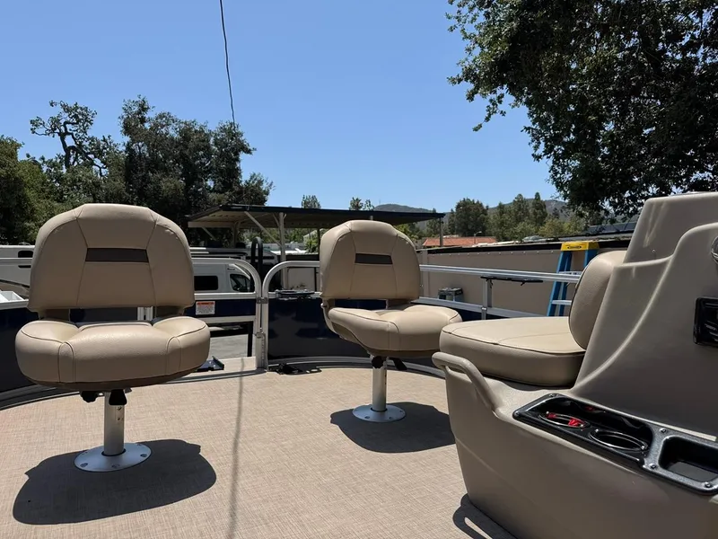 Slide: The Image of 2023 Sun Tracker Bass Buggy 16 XL Select pontoon boat interior with seating and console. - 14