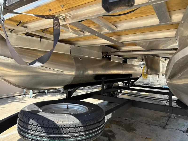 Slide: The Image of Underneath view of 2023 Sun Tracker Bass Buggy 16 XL Select pontoon boat on trailer. - 23