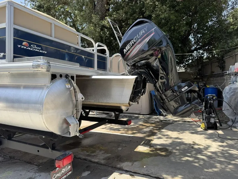 Slide: The Image of 2023 Sun Tracker Bass Buggy 16 XL Select with Mercury outboard motor on trailer. - 25