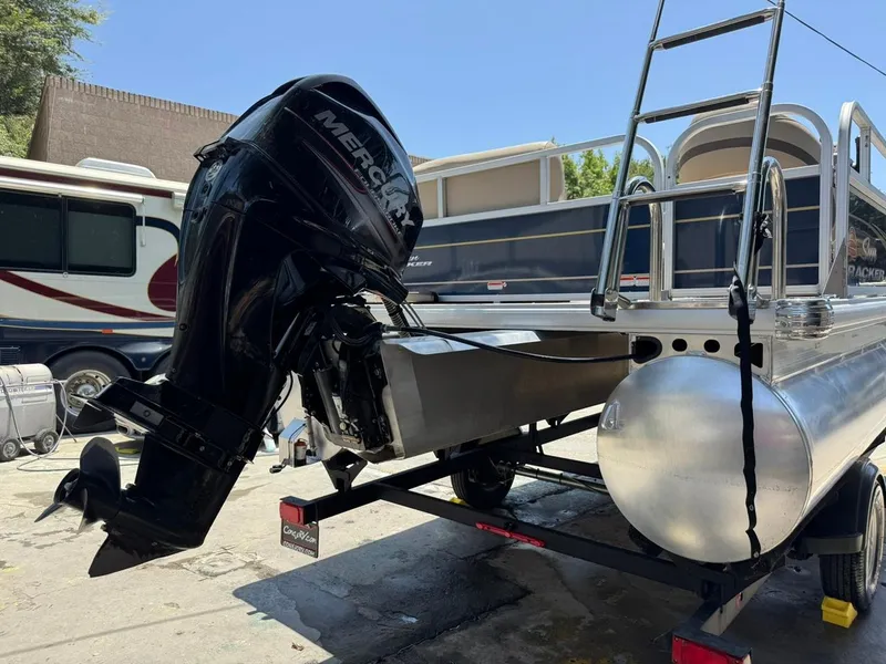 Slide: The Image of 2023 Sun Tracker Bass Buggy 16 XL Select with Mercury outboard motor on trailer. - 26