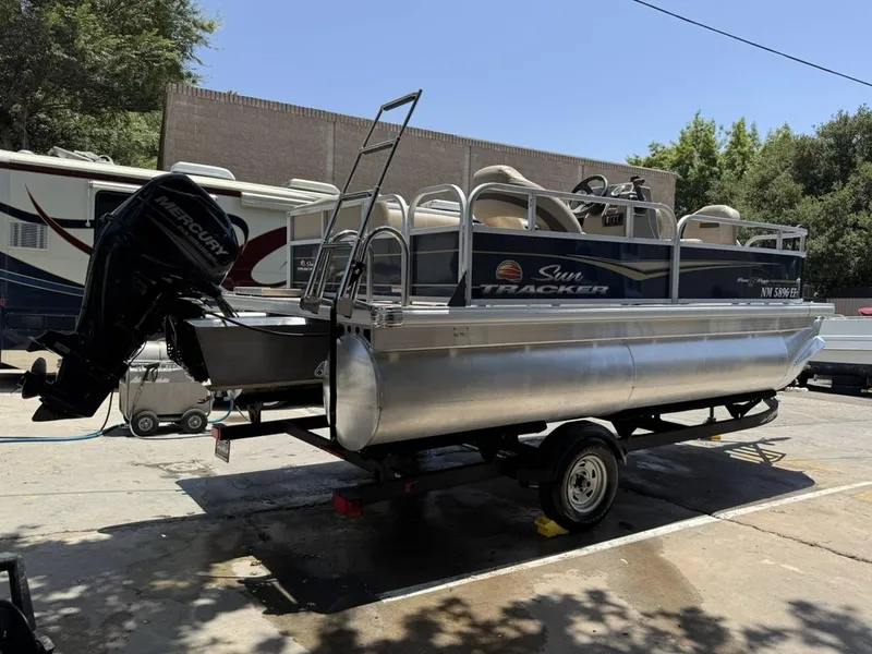 Slide: The Image of 2023 Sun Tracker Bass Buggy 16 XL Select pontoon boat on trailer. - 3