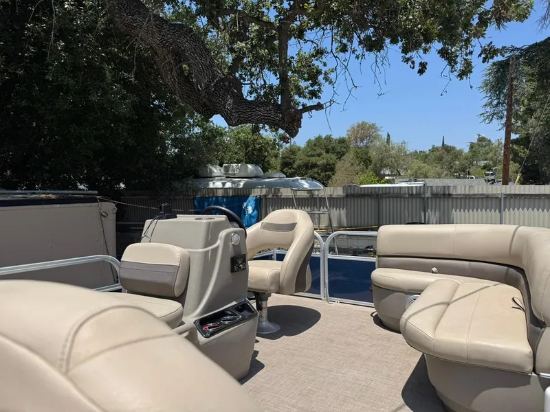 Slide: The Image of 2023 Sun Tracker Bass Buggy 16 XL Select pontoon boat interior with beige seating. - 5