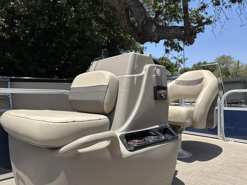 Slide: The Image of 2023 Sun Tracker Bass Buggy 16 XL Select boat interior with beige seating and console. - 7