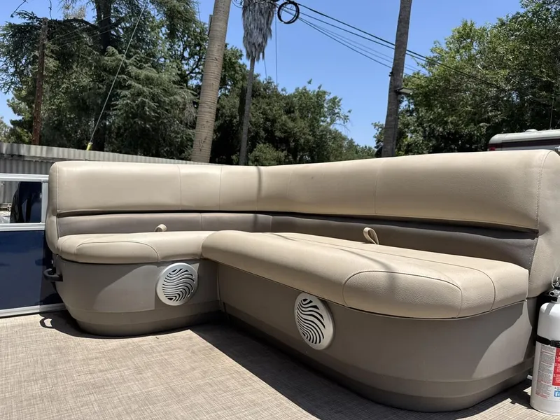 Slide: The Image of 2023 Sun Tracker Bass Buggy 16 XL Select boat seating with beige upholstery and built-in speakers. - 8