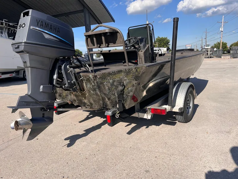 Slide: The Image of 2007 Lakesport 1860 boat with Yamaha 90 engine on trailer, parked outdoors. - 3