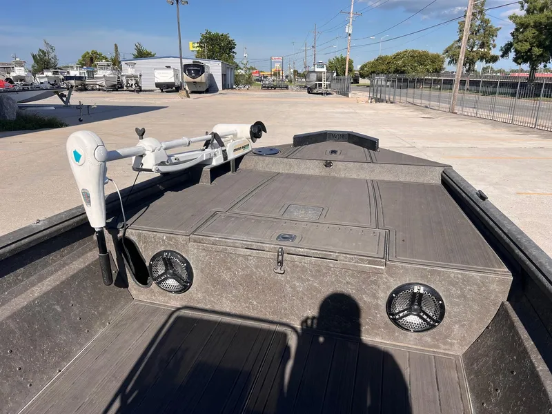 Slide: The Image of 2007 Lakesport 1860 boat with trolling motor and speakers, parked in a lot. - 9