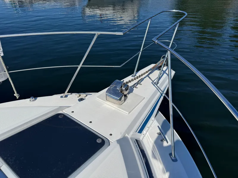 Slide: The Image of Bow of 1990 Carver 30 Santego yacht with anchor chain and railing. - 15