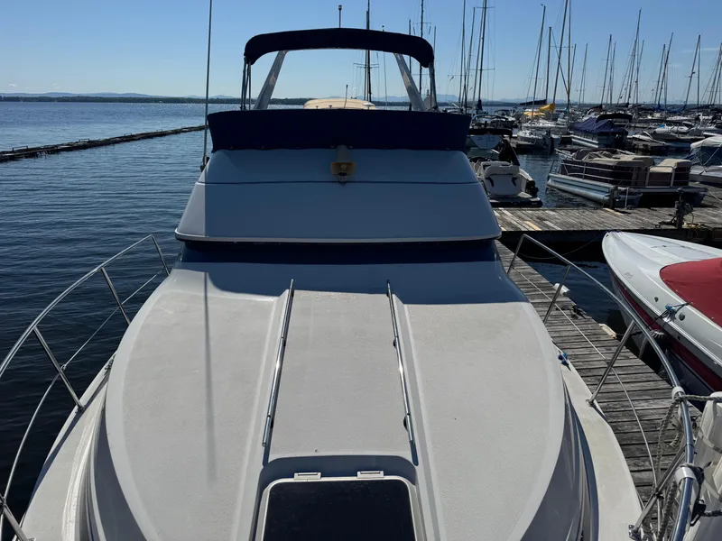 Slide: The Image of 1990 Carver 30 Santego yacht docked at marina, surrounded by other boats. - 16