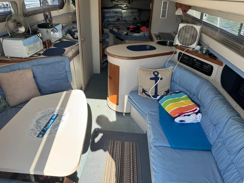 Slide: The Image of Interior of a 1990 Carver 30 Santego boat with cozy seating and nautical decor. - 5