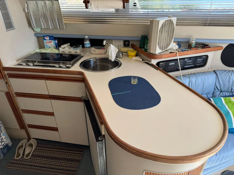 Slide: The Image of Interior of a 1990 Carver 30 Santego yacht kitchen with sink and stove. - 7