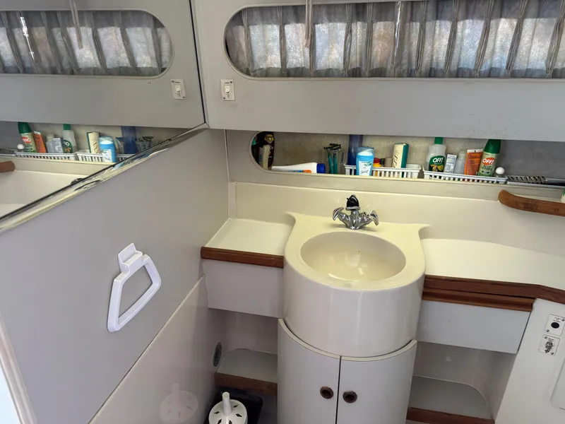 Slide: The Image of 1990 Carver 30 Santego bathroom with sink, mirror, and toiletries. - 13