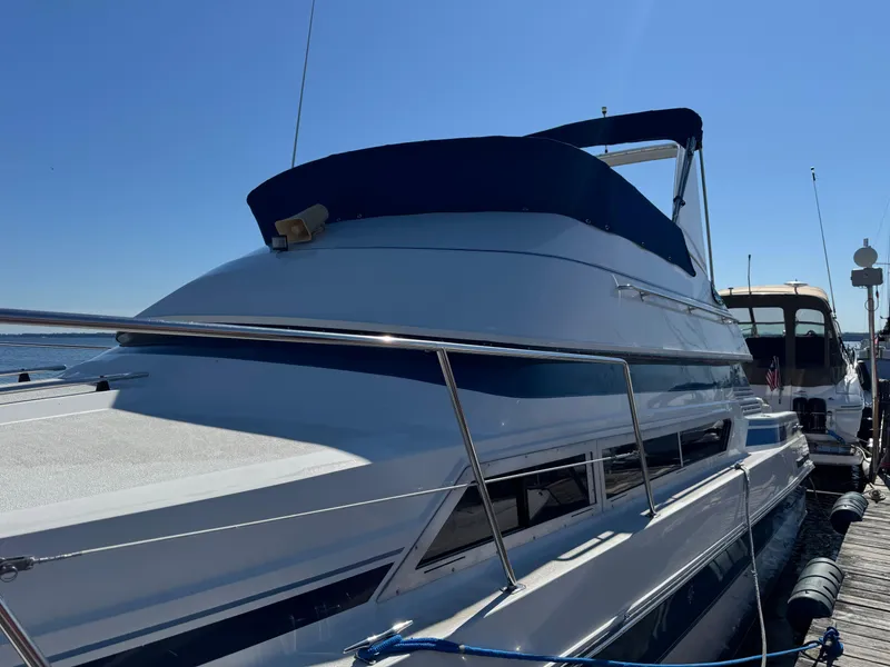 Slide: The Image of 1990 Carver 30 Santego yacht docked under clear blue sky. - 14