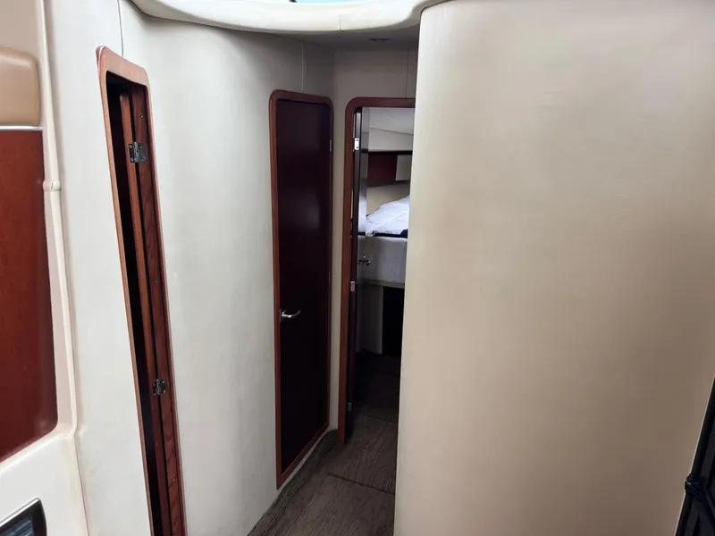 Slide: The Image of Interior hallway of 2005 Sea Ray 420 Sedan Bridge yacht, featuring wooden doors and cozy cabin. - 13