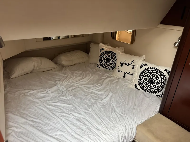 Slide: The Image of Cozy bedroom in 2005 Sea Ray 420 Sedan Bridge with decorative pillows and white bedding. - 14