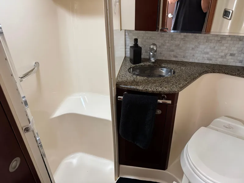 Slide: The Image of Luxurious bathroom in 2005 Sea Ray 420 Sedan Bridge yacht with shower, sink, and toilet. - 16