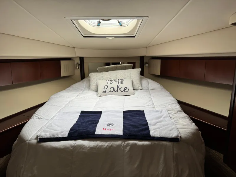 Slide: The Image of Cozy bedroom in 2005 Sea Ray 420 Sedan Bridge yacht with skylight and decorative pillows. - 17