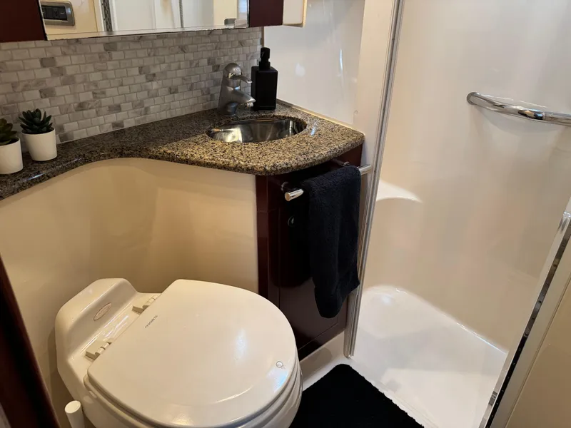Slide: The Image of Luxurious bathroom in 2005 Sea Ray 420 Sedan Bridge yacht with granite countertop and modern fixtures. - 20