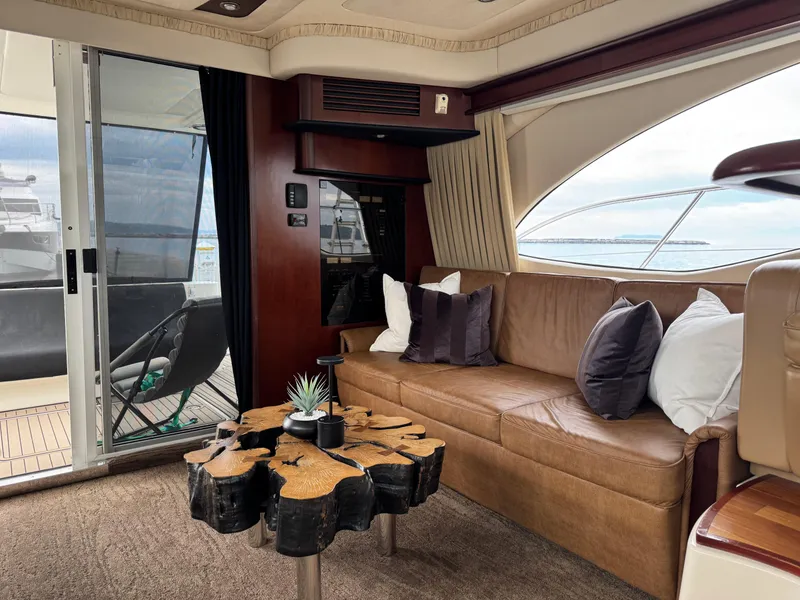 Slide: The Image of Luxurious interior of 2005 Sea Ray 420 Sedan Bridge yacht with elegant seating and unique table. - 25