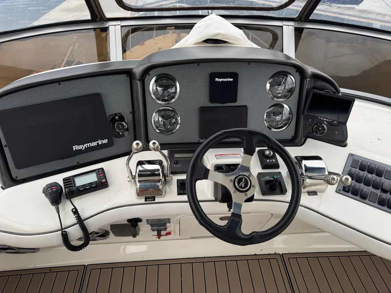 Slide: The Image of Helm of 2005 Sea Ray 420 Sedan Bridge with Raymarine electronics and steering wheel. - 28