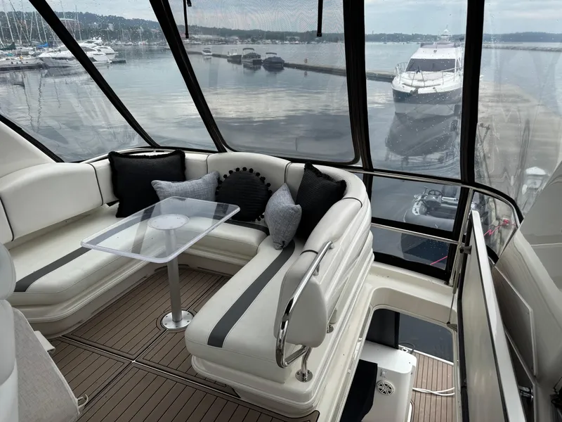 Slide: The Image of Luxurious 2005 Sea Ray 420 Sedan Bridge interior with elegant seating and scenic marina view. - 29