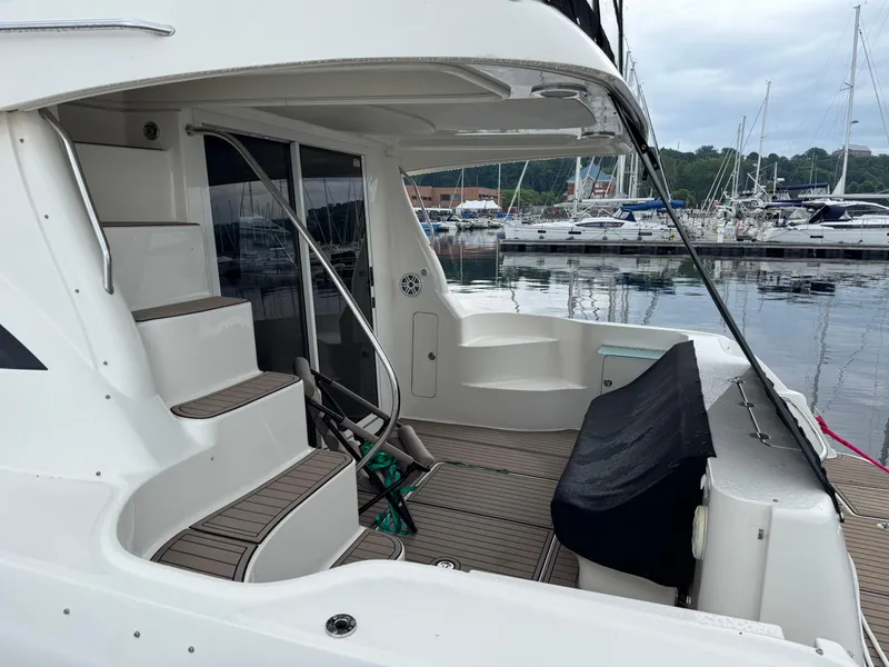 Slide: The Image of 2005 Sea Ray 420 Sedan Bridge yacht docked, featuring spacious deck and elegant design. - 3