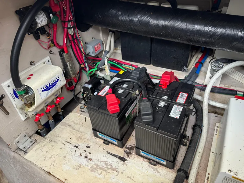 Slide: The Image of Engine compartment of a 2005 Sea Ray 420 Sedan Bridge with batteries and wiring. - 33