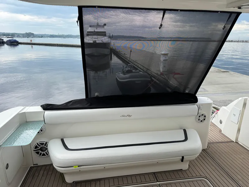 Slide: The Image of 2005 Sea Ray 420 Sedan Bridge yacht with white seating and waterfront view. - 35