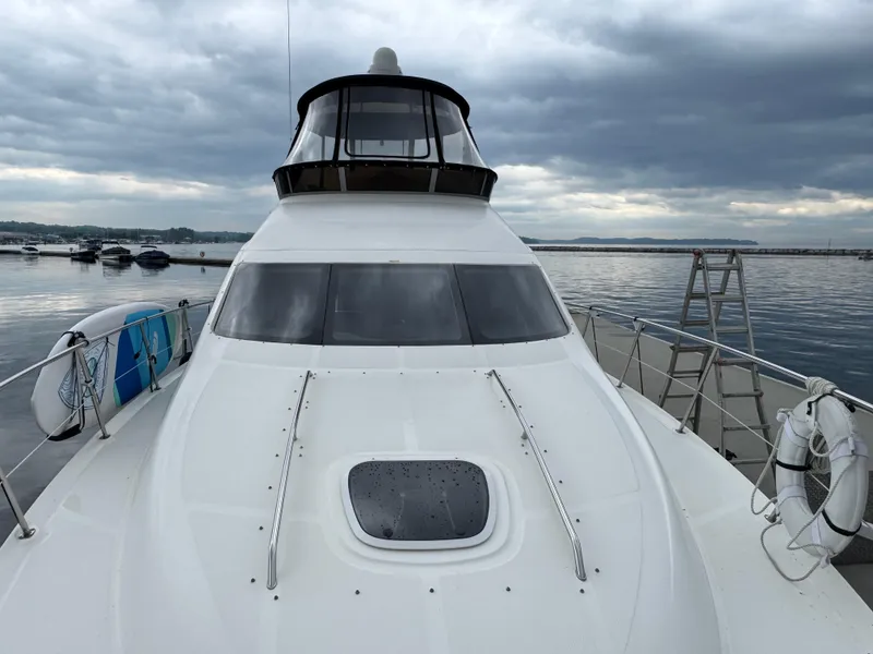 Slide: The Image of 2005 Sea Ray 420 Sedan Bridge yacht docked on a cloudy day. - 37