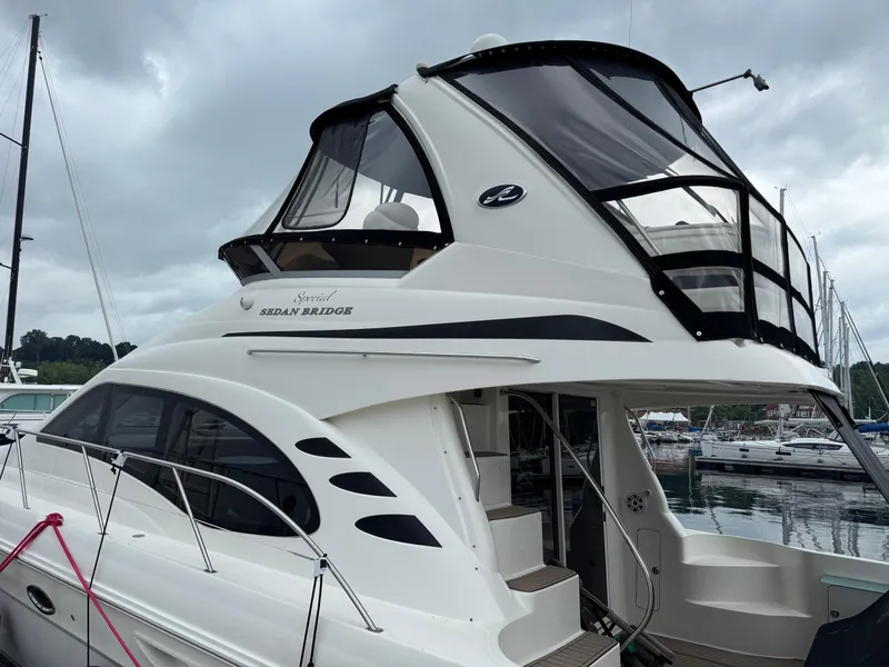 Slide: The Image of 2005 Sea Ray 420 Sedan Bridge yacht docked at marina under cloudy sky. - 38