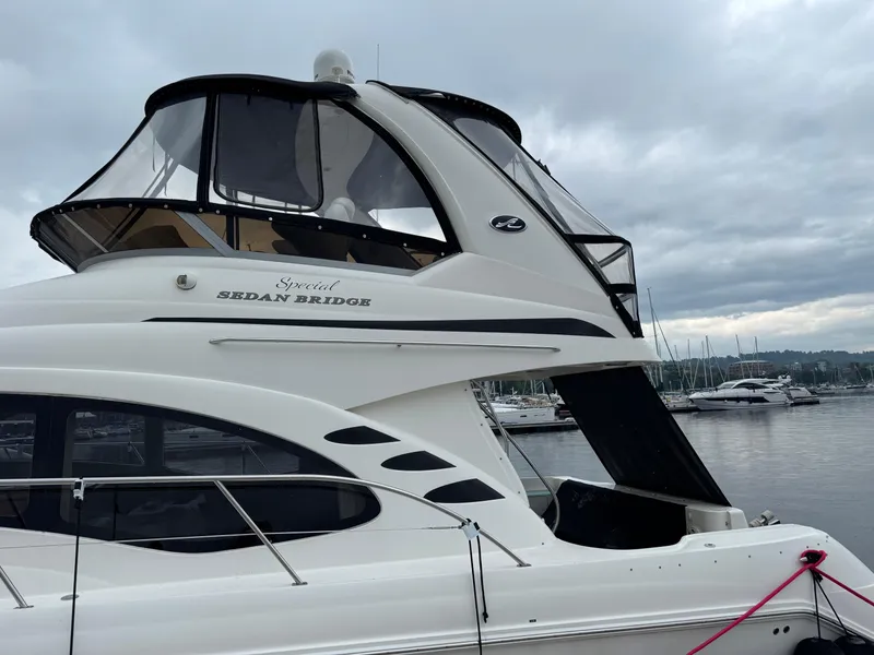 Slide: The Image of 2005 Sea Ray 420 Sedan Bridge yacht docked at marina under cloudy sky. - 39