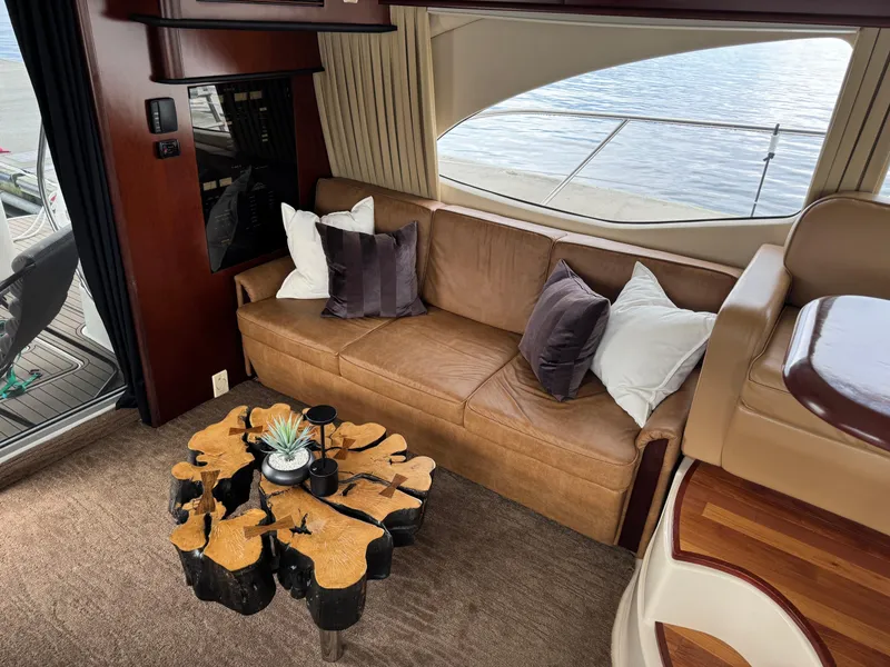 Slide: The Image of Luxurious interior of 2005 Sea Ray 420 Sedan Bridge with leather sofa and unique wooden table. - 7