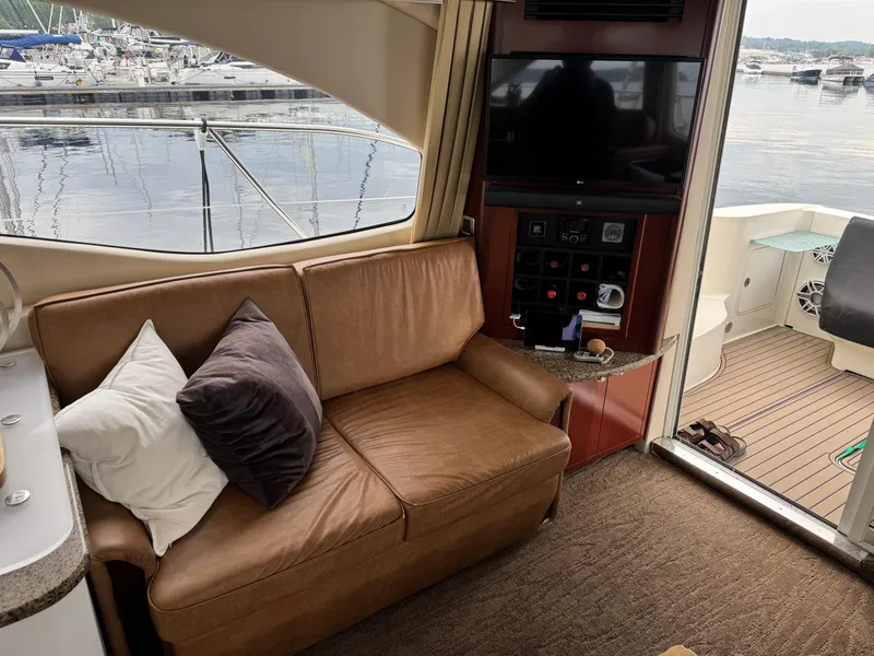 Slide: The Image of Interior of 2005 Sea Ray 420 Sedan Bridge with leather sofa and entertainment system. - 9