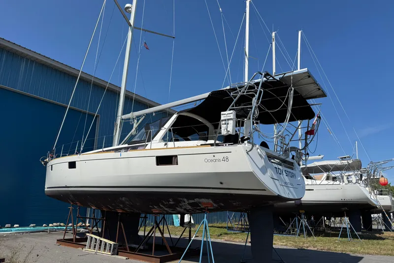 Slide: The Image of 2013 Beneteau Oceanis 48 sailboat on stands, blue sky background. - 11