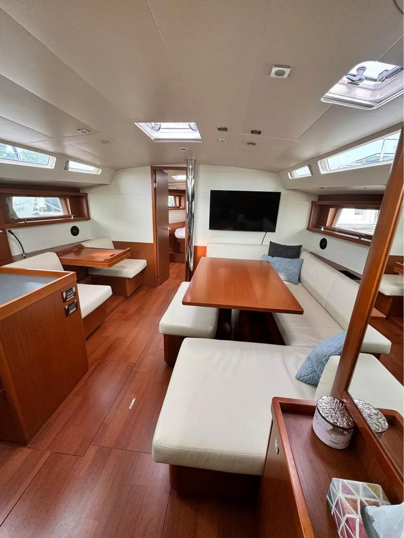 Slide: The Image of Interior of 2013 Beneteau Oceanis 48 yacht with elegant wood finish and comfortable seating. - 3