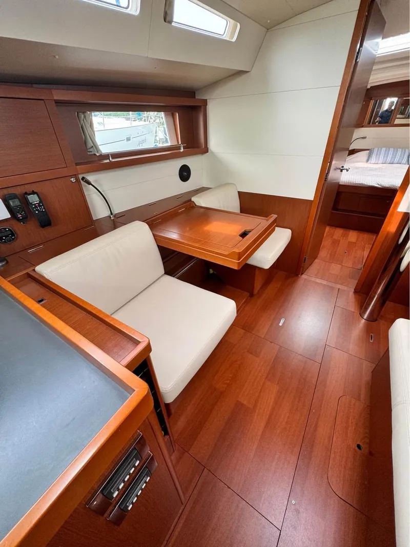 Slide: The Image of Interior of 2013 Beneteau Oceanis 48 yacht with wood finish and seating area. - 4