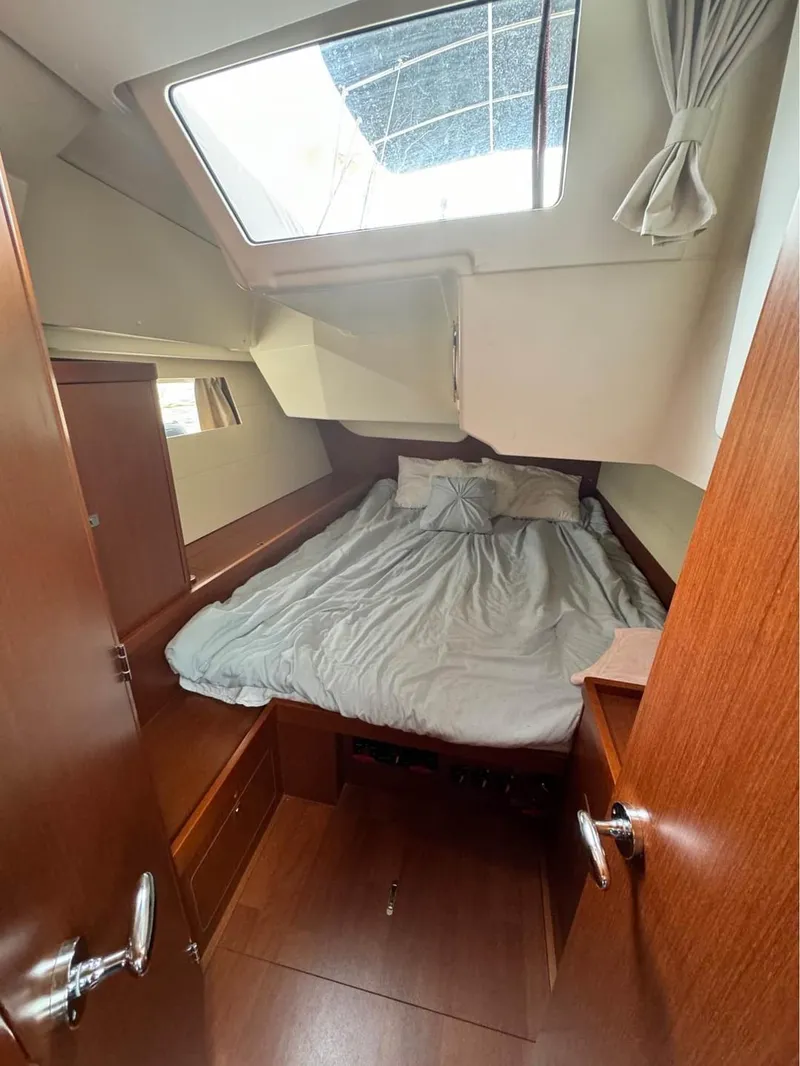 Slide: The Image of Cozy cabin interior of 2013 Beneteau Oceanis 48 sailboat with skylight and bed. - 7
