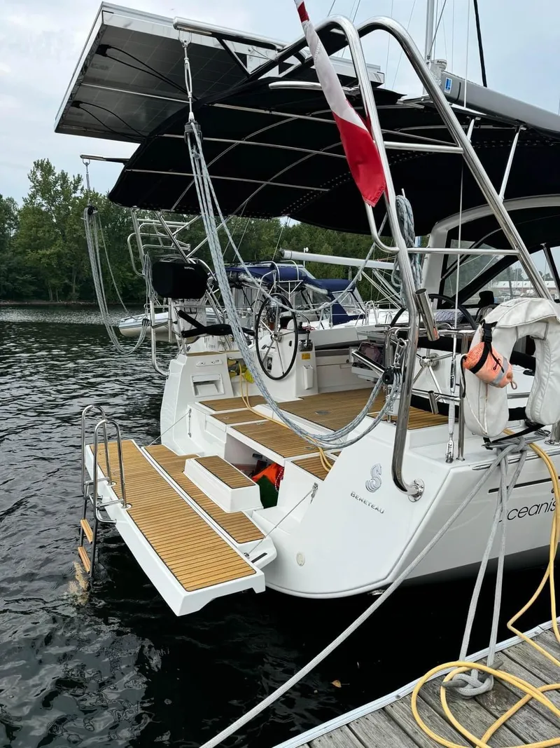 Slide: The Image of 2013 Beneteau Oceanis 48 yacht docked, featuring spacious deck and modern design. - 8