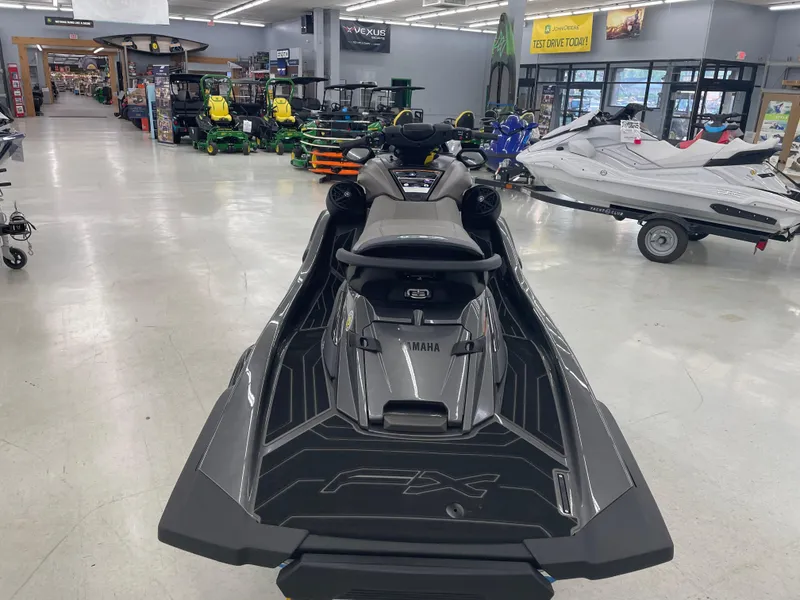 Slide: The Image of 2025 Yamaha WaveRunner FX Cruiser HO displayed in a showroom with various equipment. - 2