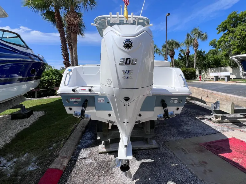 Slide: The Image of 2024 Sea Hunt Ultra 239 SE boat with powerful 300 VE engine, parked outdoors. - 24