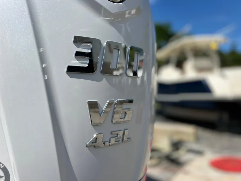Slide: The Image of Close-up of 2024 Sea Hunt Ultra 239 SE engine, featuring 300 V6 4.2L badge. - 26