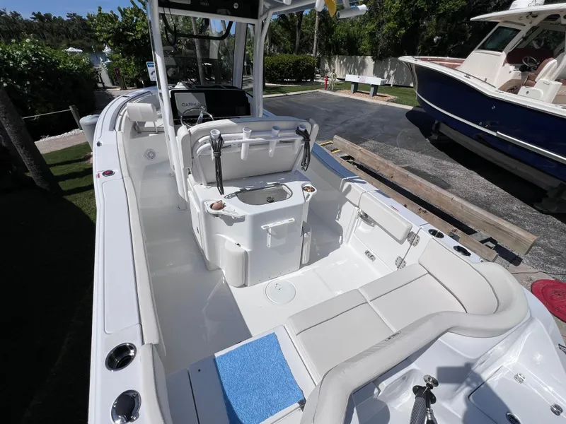 Slide: The Image of 2024 Sea Hunt Ultra 239 SE boat interior with seating and console. - 27