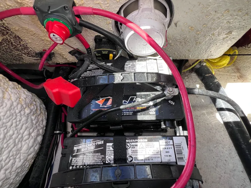 Slide: The Image of Battery compartment of 2024 Sea Hunt Ultra 239 SE boat with wiring and connections. - 32
