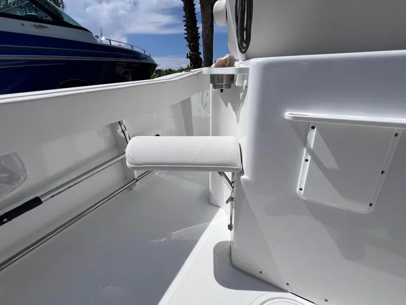 Slide: The Image of 2024 Sea Hunt Ultra 239 SE boat interior with foldable seat and storage compartments. - 35