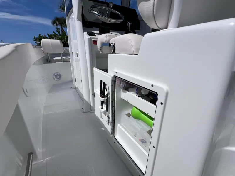 Slide: The Image of 2024 Sea Hunt Ultra 239 SE boat interior with storage compartment and seating. - 37