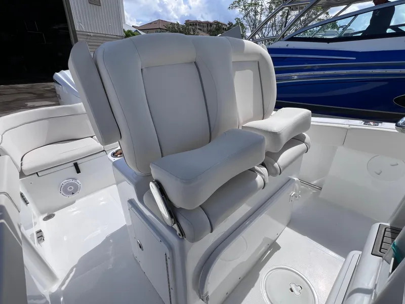 Slide: The Image of 2024 Sea Hunt Ultra 239 SE boat interior with white cushioned seating. - 40